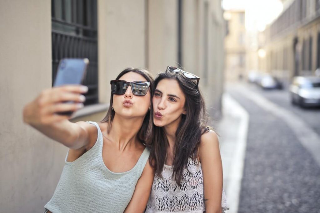 presente para irmã - duas moças fazem selfie com biquinho em rua
